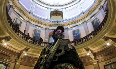 An armed extremist stands in the Michigan Capitol building in Lansing, Michigan, in April 2020 as part of a protest against Governor Gretchen Whitmer’s coronavirus stay-at-home order. Subsequently several people were charged with a plot to kidnap Whitmer.