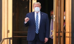 US President Donald Trump makes a fist as he walks out the front doors of Walter Reed National Military Medical Center after a fourth day of treatment for the coronavirus disease (COVID-19) as he heads to the Marine One helicopter to return to the White House in Washington from the hospital in Bethesda, Maryland, US, 5 October 2020.