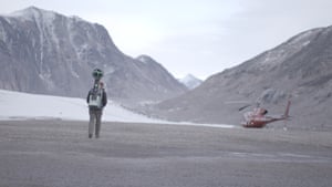 Expedition helicopter at the foot of a glacierThe land where Coster-Waldau is walking was covered by the glacier in previous years, an indication of the rate the ice is retreating.
