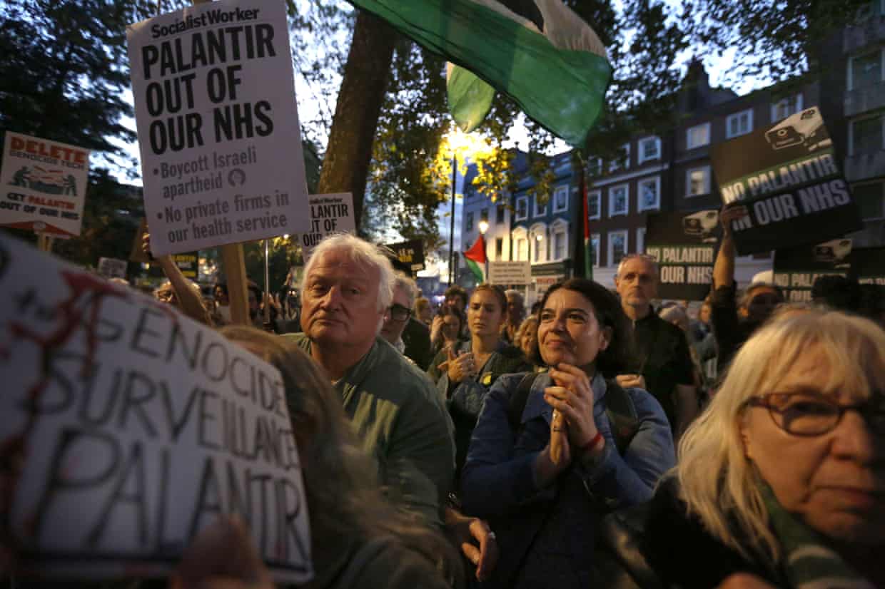 Protesters wave a banner calling for Palantir to be kept out of the NHS