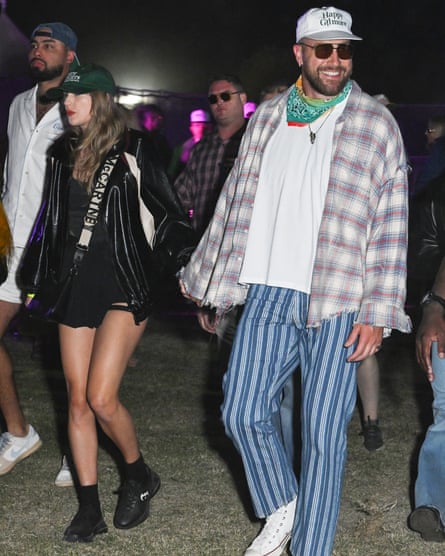 A woman wearing black shorts and a black top with a man wearing a check shirt and stripy trousers