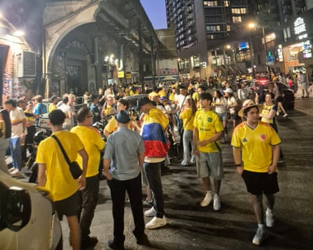 Fans in yellow shirts at night in the city