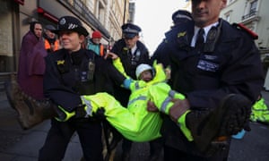 Police arresting an XR protester