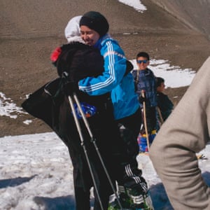 Nazira hugs a friend in celebration after realising she has won the Afghan Ski Challenge ladies race