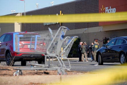 FBI agents talk as they gather after a mass shooting at a Walmart in Chesapeake, Virginia.