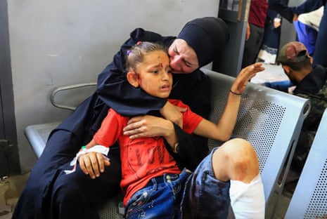 A Palestinian girl, wounded in an Israeli strike, according to the Gaza Health Ministry, looks on as she receives treatment at Al-Shifa hospital in Gaza City.