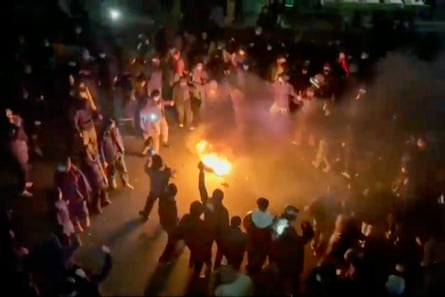 Protesters dance and cheer around a bonfire as they take to the streets in Tehran, Iran.