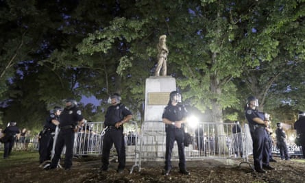 Police surround the ‘Silent Sam’ Confederate monument during a protest to remove the statue at the University of North Carolina in Chapel Hill, NC August 2017