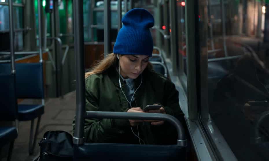 Young woman riding in public transportation by night