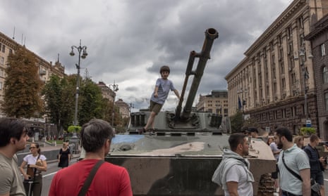A boy stands on a Russian armored military vehicle that was damaged in fights with the Ukrainian army, displayed on Khreshchatyk street, in downtown Kyiv, ahead of ‘Independence Day’,. Ukrainians will mark the 31st anniversary of Ukraine’s independence from the Soviet Union in 1991.
