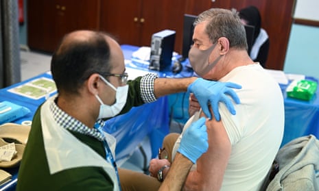 A pharmacist administers a vaccine dose in Birmingham.