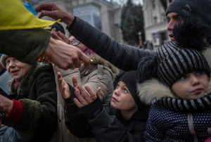 A child receives aid supplies in the centre of Kherson