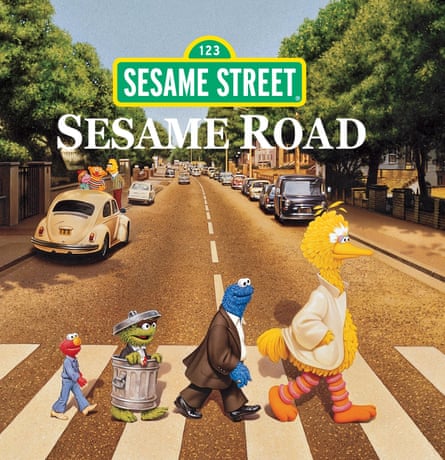 Big Bird, Cookie Monster, Oscar the Grouch and Elmo walk in single file across a zebra crossing