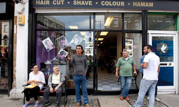 Turkish men outside barber's shop in Dalston, London