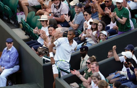 Felix Auger-Aliassime ends up in a spectator exit after chasing across court to retrieve a drop shot from his opponent Dino Prizmic.