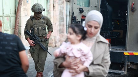 Israeli soldiers standing guard in an alleyway in Hebron, West Bank.