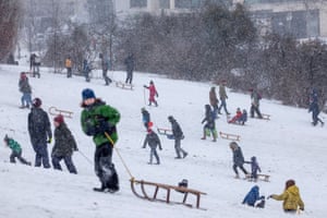 People enjoy the snow on the second day of a severe snow storm across Germany.