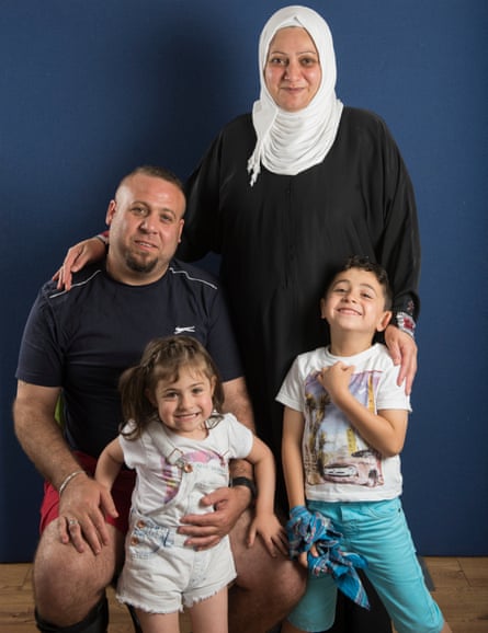 Syrian refugees Husn Alsankari and her husband Haiyan Srihini with two children