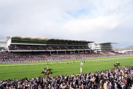 Dinoblue ridden by Mark Walsh (nearside) on their way to winning the Mrs Paddy Power Mares’ Chase on day four of the 2026 Cheltenham festival