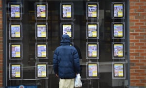 A man is seen looking at houses for sale at Butter Jon Bee’s estate agents in Stoke-on-Trent, Staffordshire.