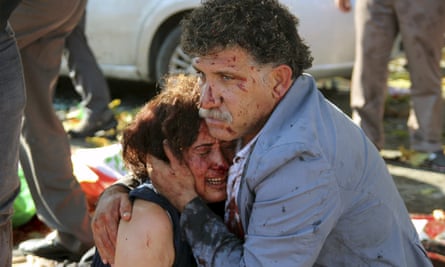 An injured man hugs an injured woman after the explosion 