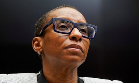 Black woman with glasses looks forward.