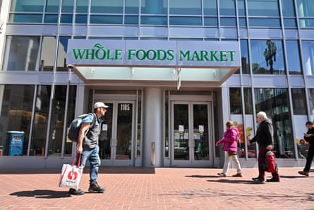 people walk in front of former whole foods