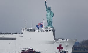 The USNS Comfort, a 1,000-plus bed Navy medical ship, sails past the Statue of Liberty in New York, 30 March 2020.