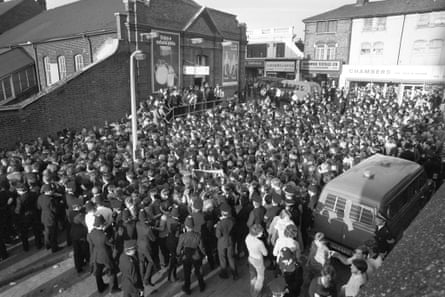 Police try to control Millwall supporters outside Upton Park station after disturbances following a defeat at West Ham in October 1978