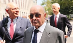 British billionaire Joe Lewis is escorted by his attorneys after leaving Manhattan federal court in New York City.