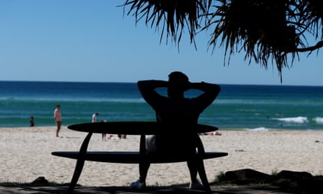 A man sits on a bench at Burleigh Heads on Saturday doing something he would not have been allowed to do the day before.