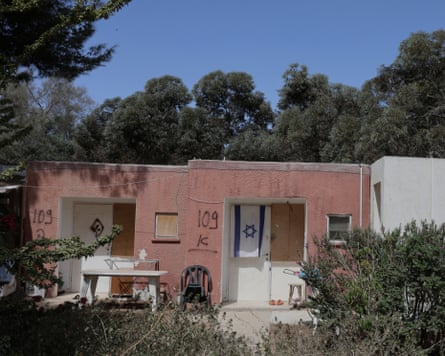 Single storey red building, with Israel flag inside one