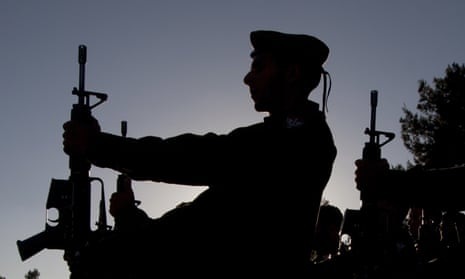 Silhouette of solider wearing hat holding gun