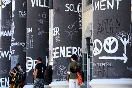 Words, words, words … visitors walk among columns scrawled with messages by Dan Perjovschi.