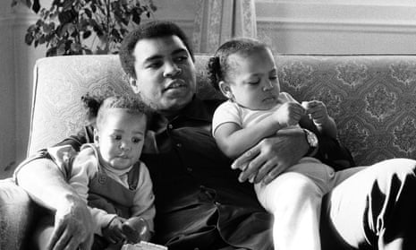 Ali cuddling his daughters Laila, (L )and Hana (R) at a Hotel in London.