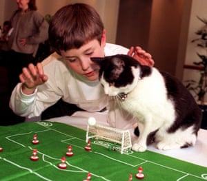 Jimmy, the 1996 Cat of the Year, with his owner, 10-year-old Andrew Tierney of Cowling, North Yorkshire. The four-year-old feline was rescued after being thrown on a bonfire and would regularly be found swiping a paw on the Subbuteo pitch.