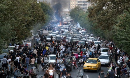 Protesters flooding a street in Tehran.
