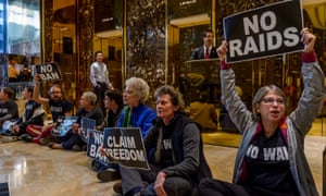 Activists unfurl anti-Trump banners inside Trump Tower to show support for refugees, immigrants, and their families in New York City earlier this month.