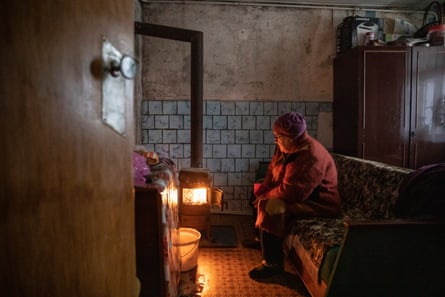 Kateryna Sliusarchuk, 71, warms her house using a burzhuika, a homemade welded metal stove
