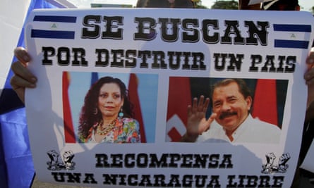 A demonstrator holds a poster depicting Nicaraguan President Daniel Ortega and his wife Vice-President Rosario Murillo reading ‘Wanted for destroying a country. Reward: A Free Nicaragua’.