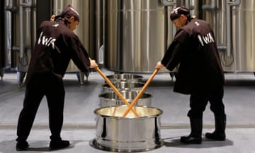 Two men brewing sake from rice