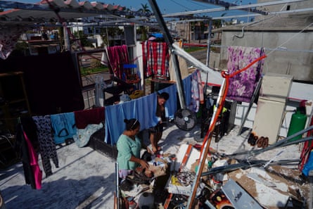 Roxana Guerrero and her husband, Jesus Rojas, work in the shell of their house in Acapulco.