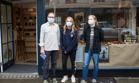 David Field and his twin daughters, Anna and Izzy, wear masks while out shopping in Devizes, Wiltshire. 