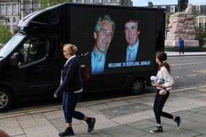 People walk past a mobile ad van that displays a photograph of the US president, Donald Trump, and the disgraced financier and sex offender Jeffrey Epstein, in protest at Trump’s visit