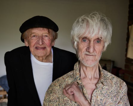 Bruce Mitchell and Vini Reilly in Manchester in 2023. Reilly in a patterned shirt and blond hair, Mitchell wearing a cap and dark jacket.