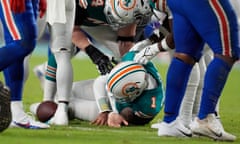 Miami Dolphins quarterback Tua Tagovailoa (1) is assisted on the field during the second half of Thursday’s game against the Buffalo Bills.