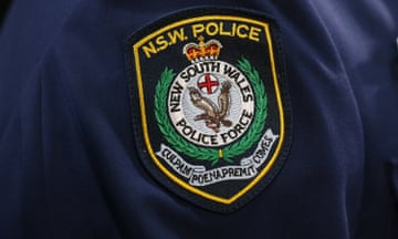 The NSW Police badge on the sleeve of NSW Police Commissioner Andrew Scipione during a press conference in Sydney, Saturday, Oct. 3, 2015. Commissioner Scipione and Premier Mike Baird addressed the media after two people were shot dead near NSW Police headquarters in Parramatta. (AAP Image/David Moir) NO ARCHIVING