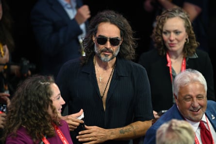 man in sunglasses amid convention crowd