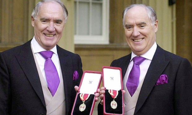 Sir David Barclay, now deceased (left) and his twin brother Sir Frederick pose after receiving their knighthoods from the Queen at Buckingham Palace in 2004.