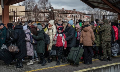 Ukrainians refugees standing on a platform at a train station